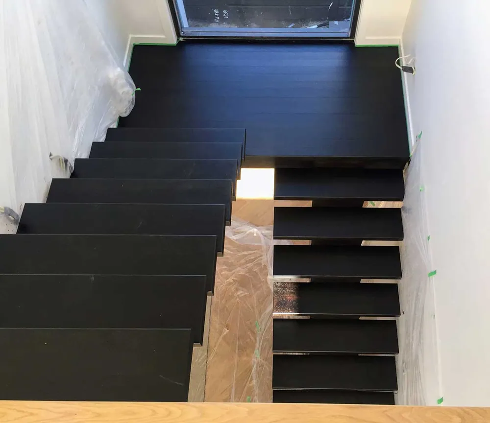 Open flight stairs with Feast Watson black Japan stain and a water-based matt finish