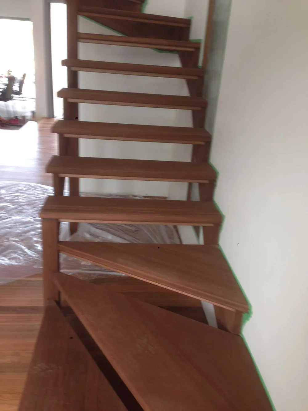 Open flight timber stairs with a walnut direct stain and polyurethane satin finish